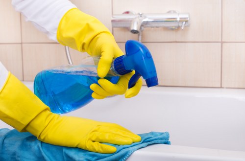 Cleaner working on upper-floor windows in Balham